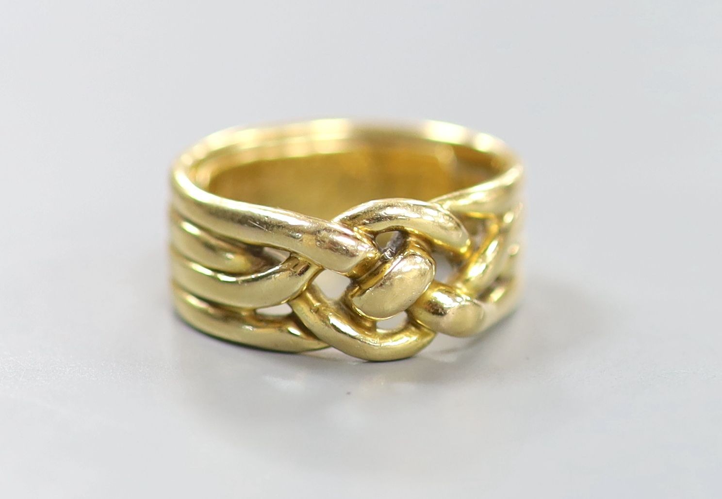 A Victorian yellow metal quadruple band knot ring, inscribed 'Joseph Massie August, 1883' size P/Q, 12.5 grams.